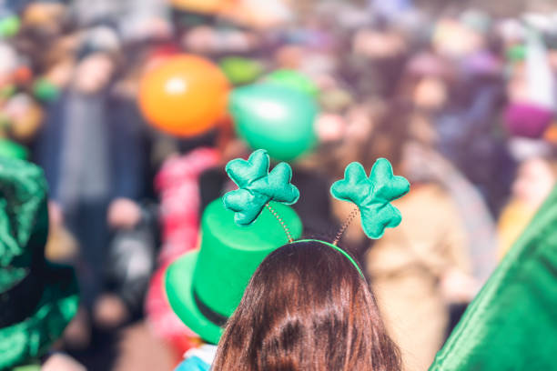 Clover head decoration on head of girl close-up. Saint Patrick day, parade in the city, selectriv focus Clover head decoration on head of girl close-up. Saint Patricks day, parade in the city, selectriv focus, copy space st patricks day stock pictures, royalty-free photos & images