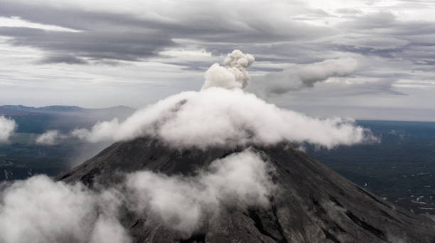 Clowds over the top of the volkano Active Avachinski volkano at Kamchatka penisula. Aerial view. active volcano stock pictures, royalty-free photos & images