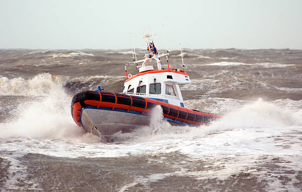 A coast guard ship on breaking waves stock photo