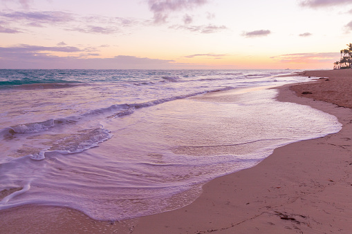 Coastal landscape with an empty sandy beach and waves in the early morning. Dominican republic. Bavaro beach