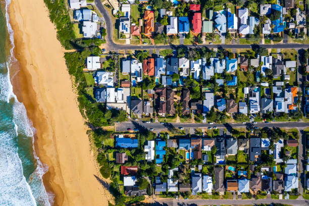 Coastal Suburb overhead perspective roof tops Suburban roof tops with beach coastal feature stock pictures, royalty-free photos & images