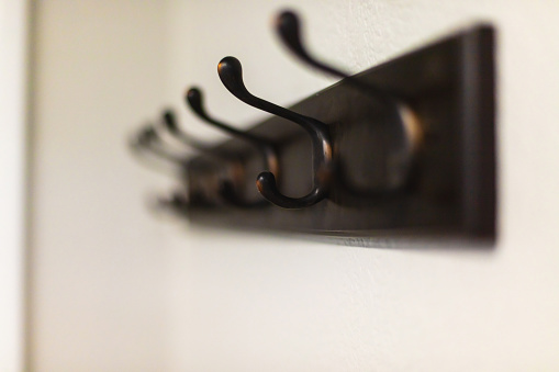 In Western Colorado Coat Hooks Attached to Black Wooden Board Hanging on a Wall Matching 4K Video Available (Shot with Canon 5DS 50.6mp photos professionally retouched - Lightroom / Photoshop - original size 5792 x 8688 downsampled as needed for clarity and select focus used for dramatic effect)