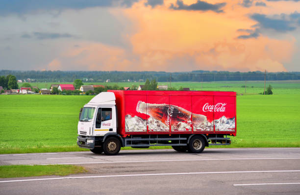 Coca Cola Truck with  driving along highway. Goods Delivery by roads. stock photo