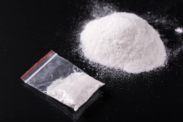 Cocaine in plastic packet on black background stock photo