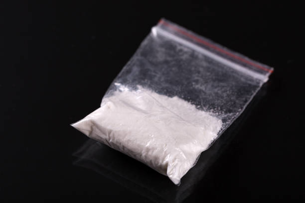 Cocaine in plastic packet on black background stock photo