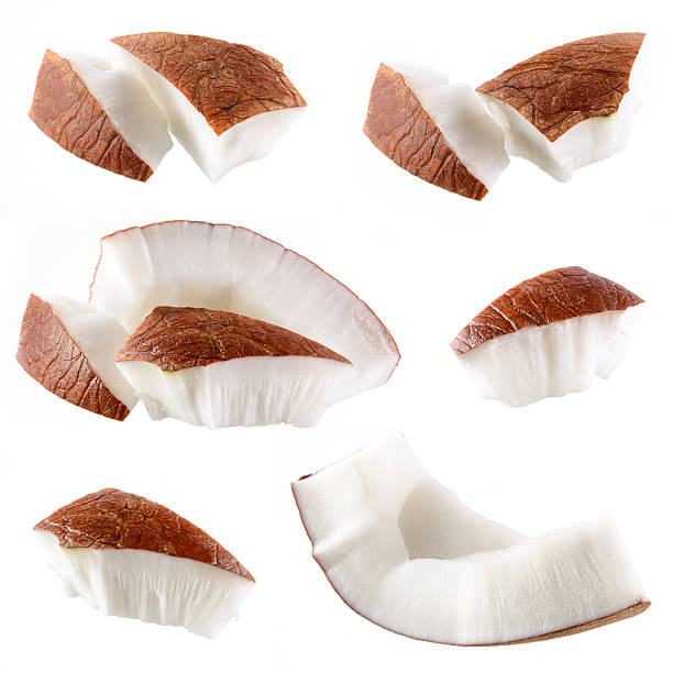 Coconut cut into jagged pieces on a white background Coconut. Pieces isolated on a white background coconut stock pictures, royalty-free photos & images