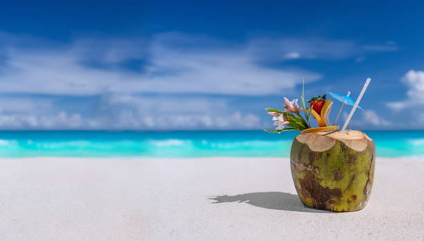 Coconut drink on a sandy beach stock photo