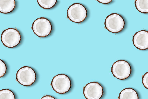 Coconut fruit  on a pastel blue background. Minimal summer concept. Flat lay.