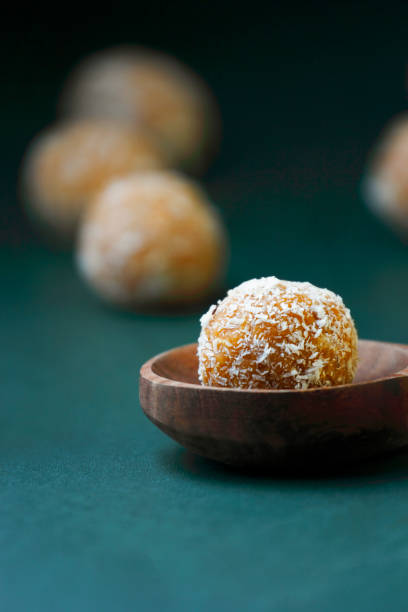 Coconut Jaggery Balls Coconut Laddoo with jaggery or Coconut Sweet Laddoo or Nariyal Laddu is a Popular Festival Food from India. Served over moody background, selective focus bengali sweets stock pictures, royalty-free photos & images