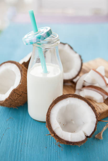 Coconut milk and fresh coconut Bottle of coconut milk and fresh coconut coconut milk stock pictures, royalty-free photos & images