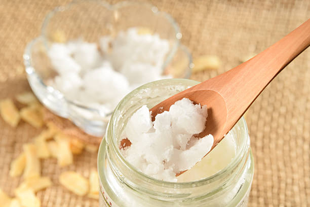 coconut oil with spoon stock photo
