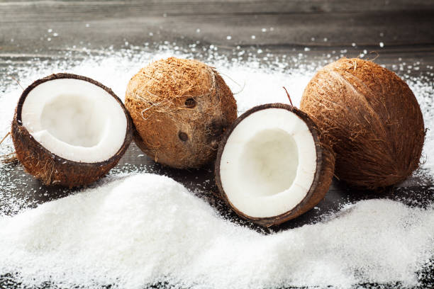 Coconut on wooden table with flour stock photo