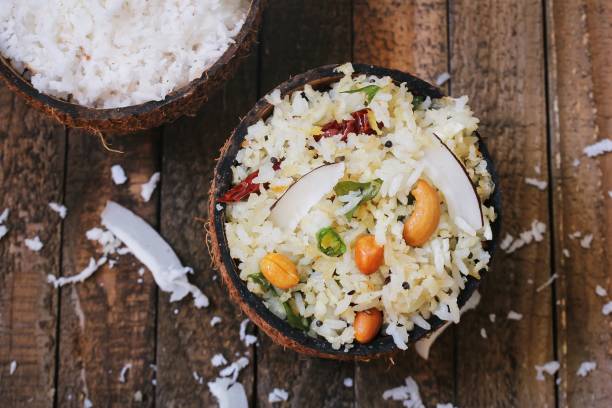 Coconut rice - South Indian one pot meal using leftover rice coconut and nuts stock photo