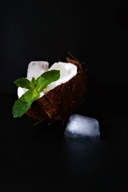 coconut with green mint leaves and ice stock photo