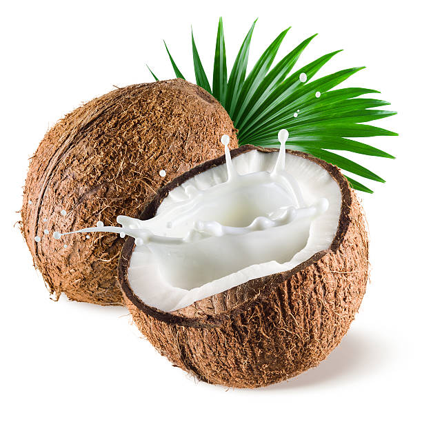 Coconut with milk splash and leaf on white background Coconut with milk splash and leaf on white background coconut milk stock pictures, royalty-free photos & images