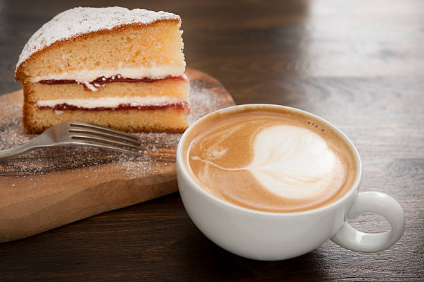 coffee and cake Flat white coffee with victoria sponge cake. cake stock pictures, royalty-free photos & images