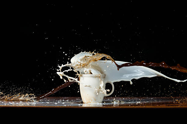 Coffee and milk pouring in a cup stock photo