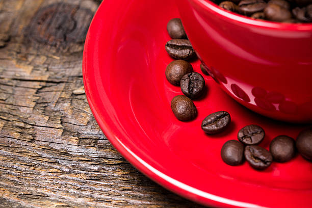 Coffee beans in red cup closeup stock photo