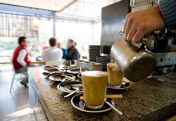 coffee being made at cafe lattes stock photo