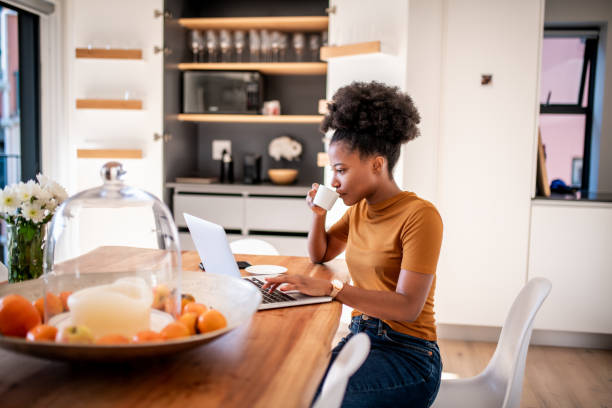 Coffee break and online shopping Young woman drinking coffee and checking the online shop surfing the net stock pictures, royalty-free photos & images