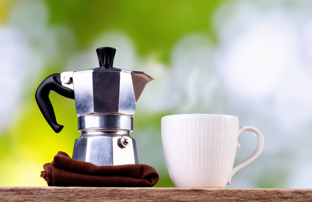 Coffee cup and coffee pot with blurred background stock photo