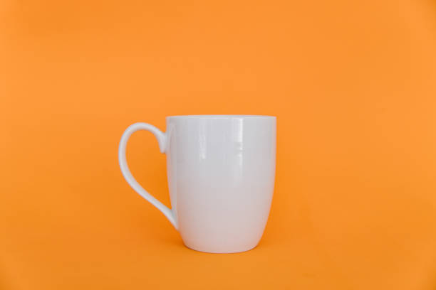 Coffee cup on an orange background stock photo