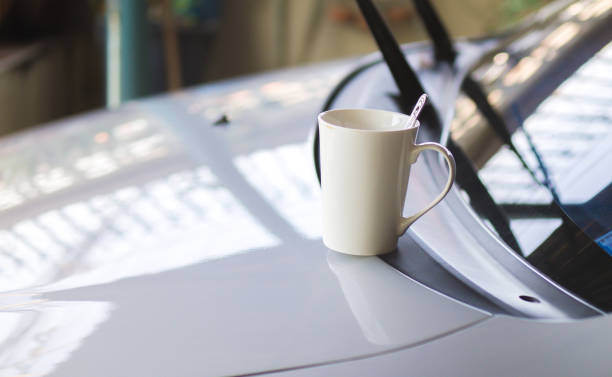 coffee cup put on front of car stock photo
