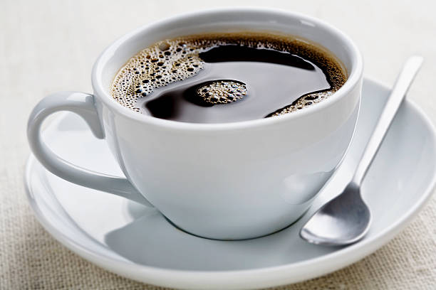 coffee cup of freshly brewed black coffee, focus is on the middle bubbles black coffee stock pictures, royalty-free photos & images