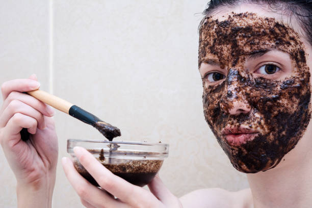 Coffee scrub Caucasian model, age 20-29 years old using a face scrub made out of coffee, honey and milk  coffee and honey scrub stock pictures, royalty-free photos & images