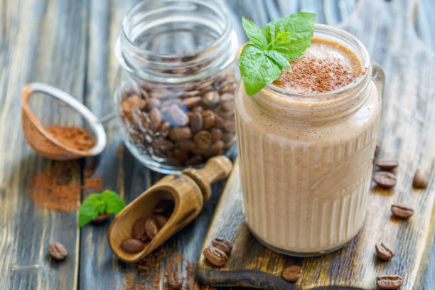 Coffee smoothie with banana in a glass jar. stock photo