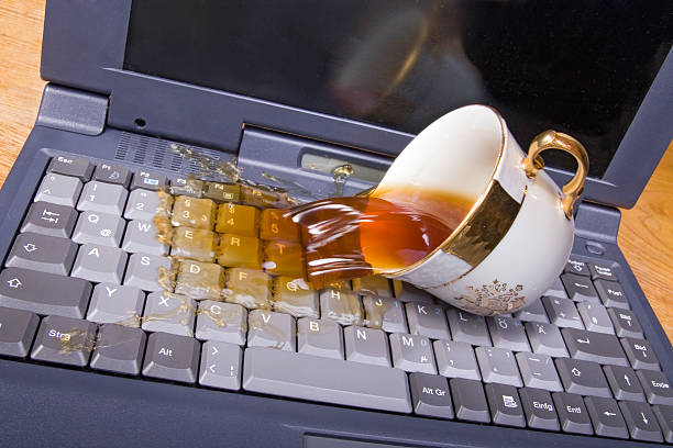 coffee spilling on keyboard stock photo