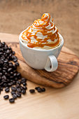 Coffee topped with fresh whipped cream and caramel sauce. (could also be a hot chocolate)