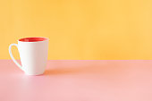istock Coffeecup On A Pink And Yellow Base 1354243928