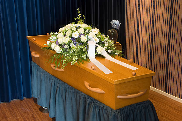 Coffin in morgue A coffin with flower arrangement in a morgue crematorium stock pictures, royalty-free photos & images