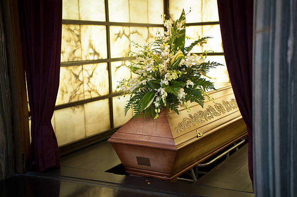 Coffin Wooden coffin with funeral flowers in crematorium undertaker stock pictures, royalty-free photos & images