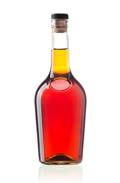 Cognac bottle The glass bottle of cognac isolated on white calvados stock pictures, royalty-free photos & images
