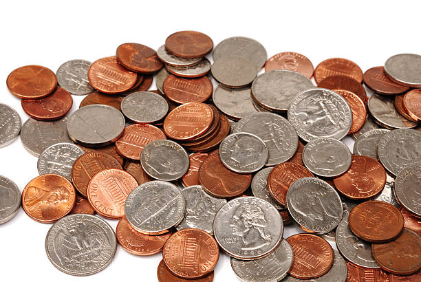 USA coins "A loosely scattered pile of American coins - pennies, nickels, dimes and quarters, on a white background." dime stock pictures, royalty-free photos & images