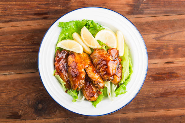 Cola chicken wings on plate stock photo