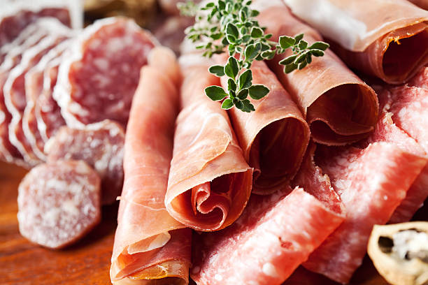Cold cuts Cold cuts: charcuterie assortment on wooden board delicatessen photos stock pictures, royalty-free photos & images