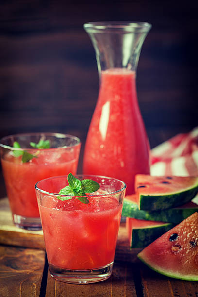 Cold Watermelon Smoothie Fresh watermelon smoothie with ice and mint watermelon juice stock pictures, royalty-free photos & images