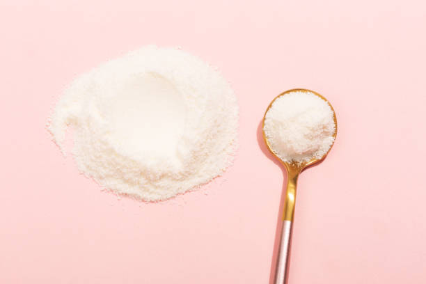 Collagen powder on pink background Collagen powder on pink background. Extra protein intake. Natural beauty and health supplement for skin, bones, joints and gut. Plant or fish based. Flatlay, top view. Copy space for your text. gelatin stock pictures, royalty-free photos & images