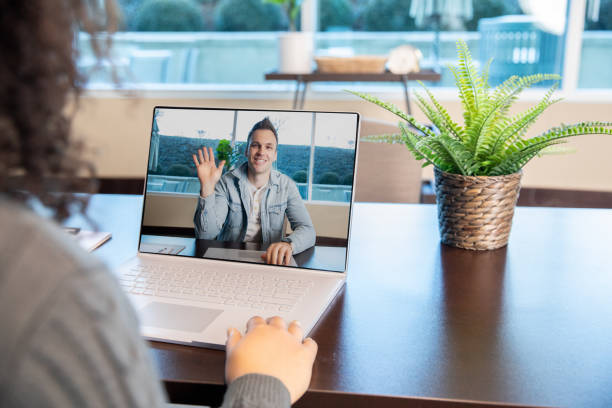 Colleagues having video call at work stock photo