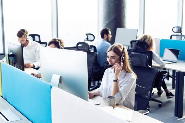 Colleagues working in a call center. Young Call Center Team Talking With Customers customer service representative stock pictures, royalty-free photos & images