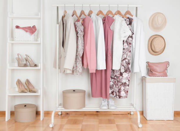 Collection of female clothes hanging on rack in dressing room  garment stock pictures, royalty-free photos & images
