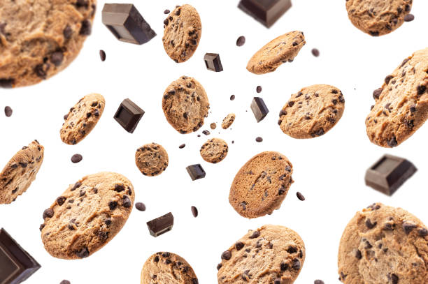 Collection of half chocolate chip cookies and pieces of delicious dark chocolate on white background stock photo