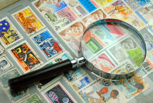 big collection of stamps and magnifier