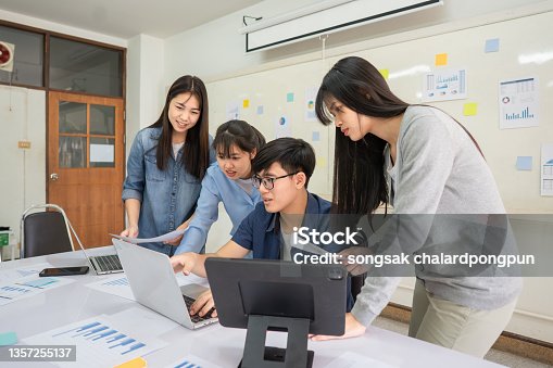 istock college students discussing project on laptop in classroom 1357255137