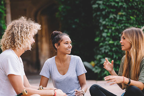 college students having a conversation stock photo