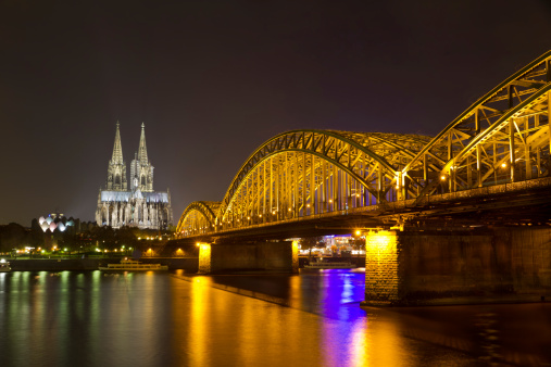 Night view of Hohenzollern Bridge and the cathedral in Cologne, Germany.