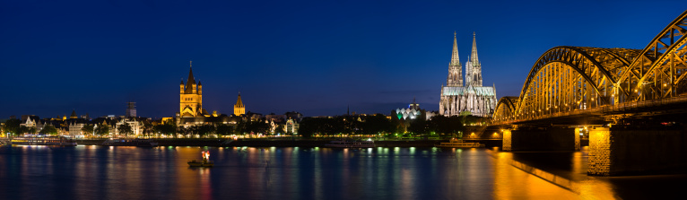 Panoramic view at the rhine river in cologne with St. Martins Curch, Cologne Cathedral and Hohenzollern Bridge.